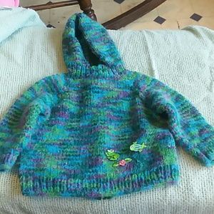A handmade knitted sweater for baby.